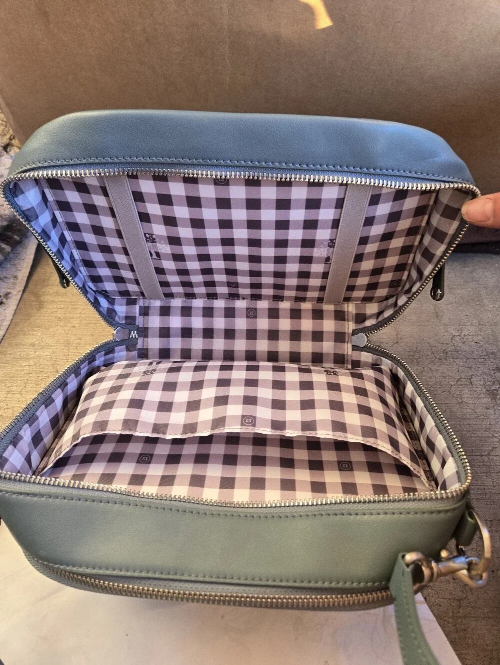 This is a TWELVElittle x The Sensible Mama Clutch in a muted blue vegan leather.